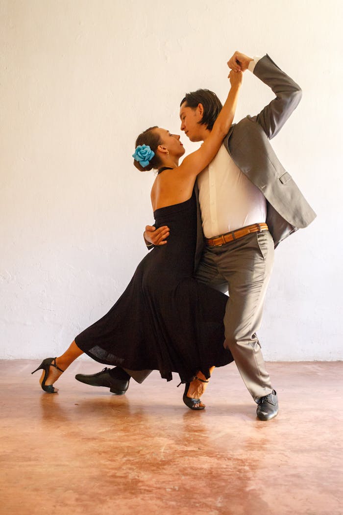 A couple immersed in a passionate tango dance, showcasing elegance and grace.